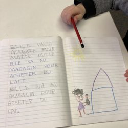 La Petite Ecole - Journaling in Kindergarten develops literacy.  "Elle va o magaze pour achete du le." (Elle va au magasin pour acheter du lait).