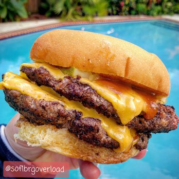 Cuban Guys - Kendall - a hand holding a cheeseburger - Cuban Near Me - Miami, Florida Cuban Guys - Kendall - a hand holding a cheeseburger - Cuban Near Me - Miami, Florida
