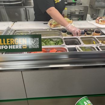 Subway - a woman serving food to a man - Sandwiches Near Me - Canton, New York