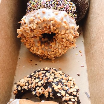 Mighty-O Donuts - From top to bottom: chocolate mint, sprinkles, nutty French toast, nutty chocolate, nutty vanilla. - Donuts Near Me - Seattle, Washington