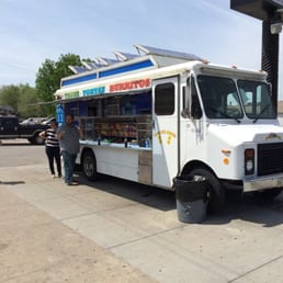 a food truck parked in a parking lot a food truck parked in a parking lot