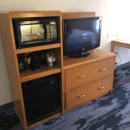 Microwave, fridge, coffee maker in room. Microwave, fridge, coffee maker in room.