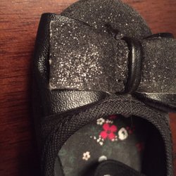 Carter's Babies & Kids - The glitter and black color is worn off and the bows have white creases in them. This is after ONE hour of wear - out to dinner!