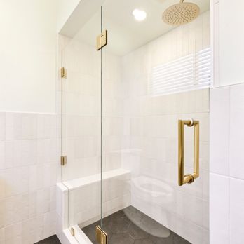 Selador Construcion - This shower features matte brass hardware, vertical white tile, a built-in bench, and bold hex flooring for a clean, modern touch. - General Contractors Near Me - Freedom, California Selador Construcion - This shower features matte brass hardware, vertical white tile, a built-in bench, and bold hex flooring for a clean, modern touch. - General Contractors Near Me - Freedom, California