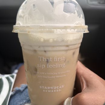 Starbucks - a person holding a cup of iced coffee - Coffee & Tea Near Me - Reedley, California