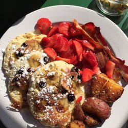 Butternut Inn and Pancake House - These were banana-blueberry pancakes w strawberries on the side. They come with potatoes and two strips of bacon.