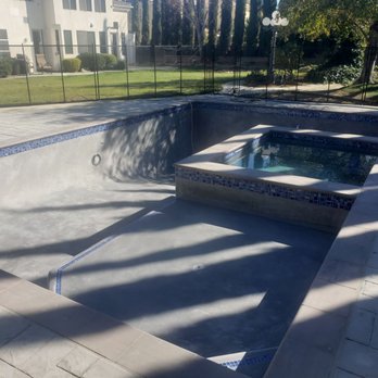 Frontier Pools - Just plastered and filling in the pool. Decking with a custom stamp. Special ordered brick coping. Glass mosaic tiles. Umbrella holder. - Pool & Hot Tub Service Near Me