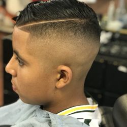 Clip Em' Up Barbershop - Medium skin fade with a comb over