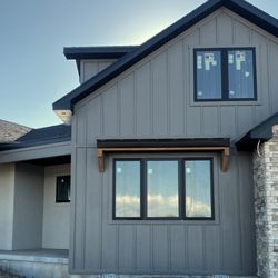 Advanced Exteriors - Make your new home beautiful with a multi-surface finish. Stucco, stone, and Hardie are featured in this new home construction.