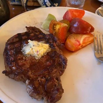 411 West Italian Cafe - Wood Grilled Beef Ribeye. 12 oz, sliced heirloom tomato, herb butter. $28. - Italian Near Me - Chapel Hill, North Carolina