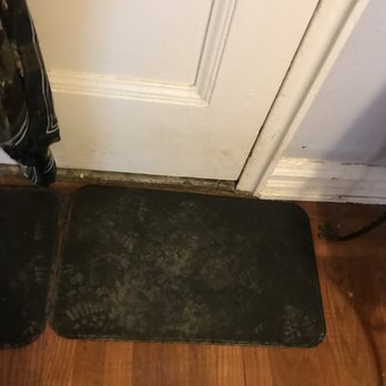RNR Home Improvements - a black mat on the floor next to a white door - General Contractors Near Me - Bronx, New York