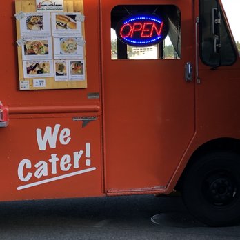 Jerusalem - an orange food truck with a menu on the side - Middle Eastern Near Me Jerusalem - an orange food truck with a menu on the side - Middle Eastern Near Me