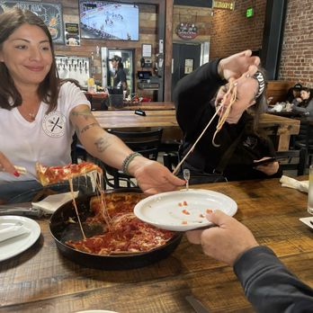 Rance's Chicago Pizza - Sharing a cheesy pizza - Pizza Near Me - Long Beach, California Rance's Chicago Pizza - Sharing a cheesy pizza - Pizza Near Me - Long Beach, California