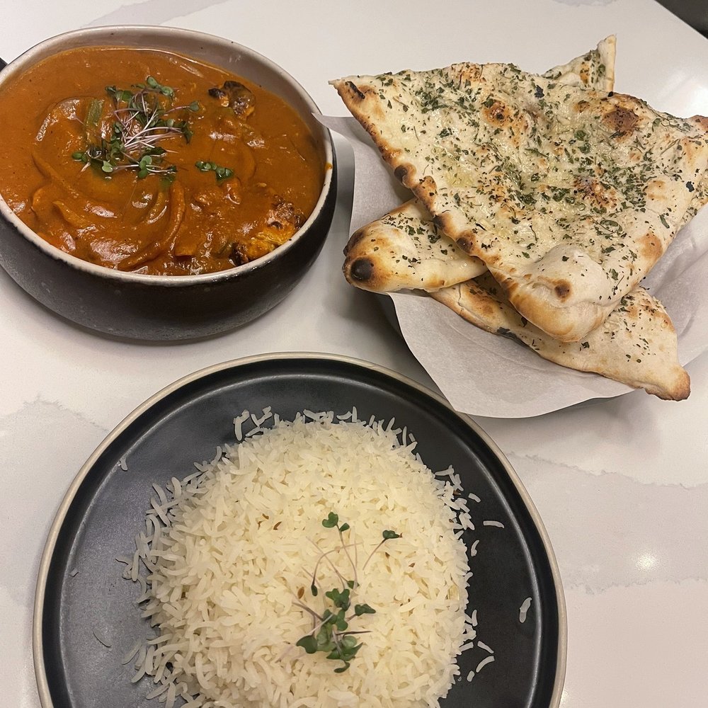 The Roaring Rolls - Chicken Tikka Masala, rice, garlic naan - Indian Near Me - Canmore, Alberta The Roaring Rolls - Chicken Tikka Masala, rice, garlic naan - Indian Near Me - Canmore, Alberta