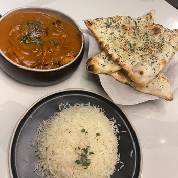 The Roaring Rolls - Chicken Tikka Masala, rice, garlic naan - Indian Near Me - Canmore, Alberta The Roaring Rolls - Chicken Tikka Masala, rice, garlic naan - Indian Near Me - Canmore, Alberta