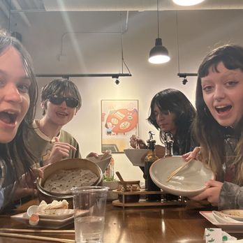 Dumpling Kitchen - four friends with empty plates and big smiles and - Noodles Near Me - Castle Rock, Colorado