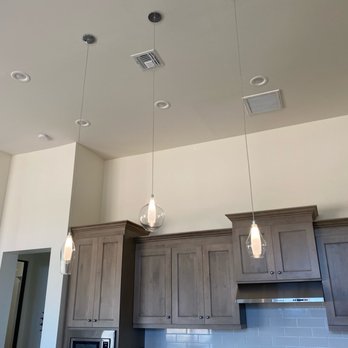 K's Lighting - Interior ceiling featuring recessed lighting, two pendant lights, and ceiling vents above kitchen cabinets in a modern home. - Lighting Fixtures & Equipment Near Me - Prescott, Arizona