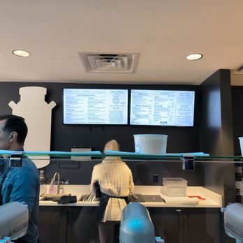 Mixter Nitrogen Creamery + Coffee - a man and a woman standing in front of the counter - Ice Cream & Frozen Yogurt Near Me - Jacksonville, Florida