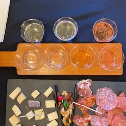 Wine and cider flight and artisan meats and cheese plate Wine and cider flight and artisan meats and cheese plate