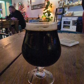 Odyssey Bottle Shop - Grabbing an oatmeal stout to drink one out for the last service of Buena Compania. - Beer Bar Near Me - Charleston, South Carolina