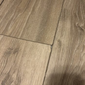 Express Flooring - Floor buckling and coming up, plus a corner broken off - Flooring Near Me