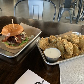 Oz. Tap House - Blue Burger with their fried pickles. The fried pickles were perfectly battered and crunchy served piping hot. - Beer Gardens Near Me - Austin, Texas