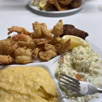 Posey's Steam Room & Oyster Bar - Shrimp, cheese grits, cole slaw and hush puppies. Catfish across the table. - Seafood Near Me - Panacea, Florida Posey's Steam Room & Oyster Bar - Shrimp, cheese grits, cole slaw and hush puppies. Catfish across the table. - Seafood Near Me - Panacea, Florida