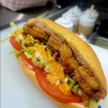 The Spot - a chicken sandwich with lettuce and tomato - Food Trucks Near Me The Spot - a chicken sandwich with lettuce and tomato - Food Trucks Near Me