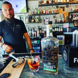 a bartender preparing a drink at a bar