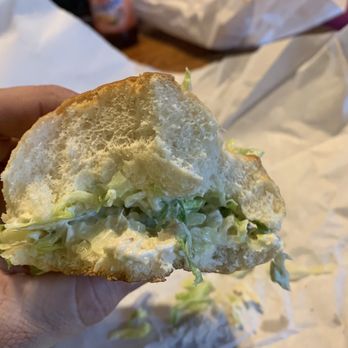 Route 115 Sub Shop - a hand holding a half eaten sandwich - Sandwiches Near Me - Effort, Pennsylvania