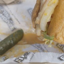 a hand holding a sandwich