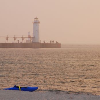 5th Avenue Beach - Manistee lighthouse. 1st street beach pier and lighthouse (across the river channel) right behind - Beaches Near Me - Manistee, Michigan