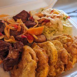 Ticas Cuisine - Our plates size
Medium
Large


This is a fried plantain plate / banann Peze
Your choice of meat
And salad