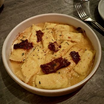 Lilia - Sheep's milk cheese agnolotti, saffron, dried tomato, honey. - Italian Near Me - Brooklyn, New York Lilia - Sheep's milk cheese agnolotti, saffron, dried tomato, honey. - Italian Near Me - Brooklyn, New York