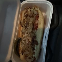 a hot dog in a styrofoam container