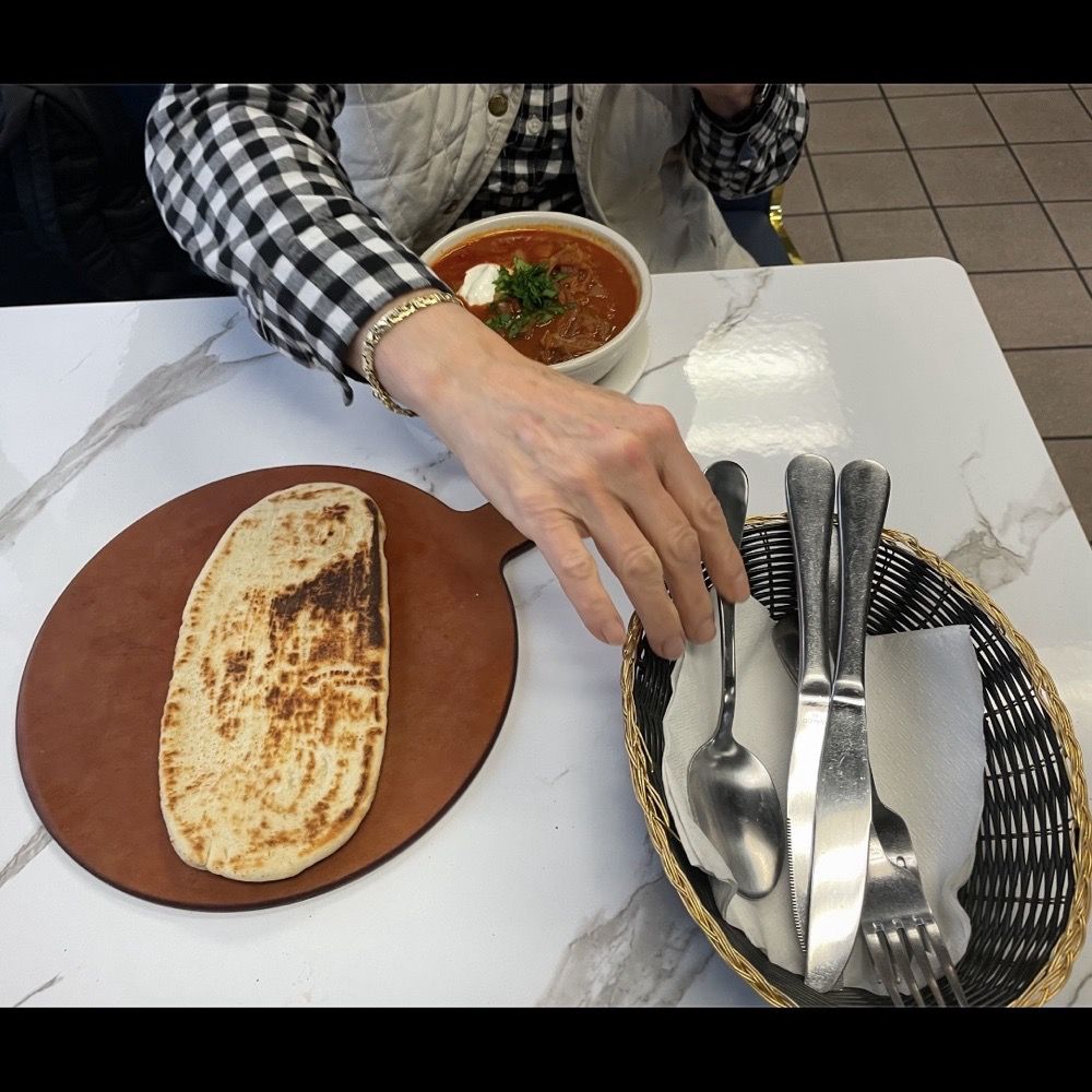 Savory hot Ukranian tomato-beet borscht soup, potatoes, shredded cabbage, carrots, onion, garlic, salt, pepper, warm fresh pita bread. Savory hot Ukranian tomato-beet borscht soup, potatoes, shredded cabbage, carrots, onion, garlic, salt, pepper, warm fresh pita bread.