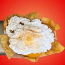 A Taste of Texas - Specialty Peach Cobbler Nachos topped with
Vanilla ice cream, whipped cream, and cinnamon sugar.