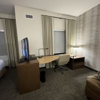 Residence Inn By Marriott - Living space that has a desk - off to the side a TV that rotates to watch either on the bed or in the living area - Hotels Near Me - Pensacola, Florida Residence Inn By Marriott - Living space that has a desk - off to the side a TV that rotates to watch either on the bed or in the living area - Hotels Near Me - Pensacola, Florida