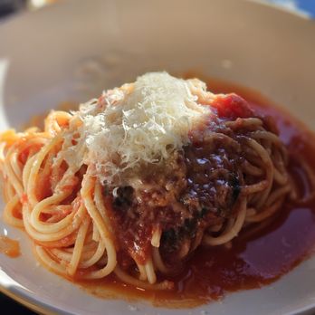 Novo Italian - a plate of spaghetti with sauce and parmesan cheese - Wine Bars Near Me - Vancouver, British Columbia Novo Italian - a plate of spaghetti with sauce and parmesan cheese - Wine Bars Near Me - Vancouver, British Columbia
