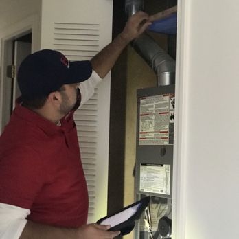 Echo Home Inspection - One of our inspectors, checking the aging and condition of the furnace. - Home Inspectors Near Me - Elgin, Illinois Echo Home Inspection - One of our inspectors, checking the aging and condition of the furnace. - Home Inspectors Near Me - Elgin, Illinois
