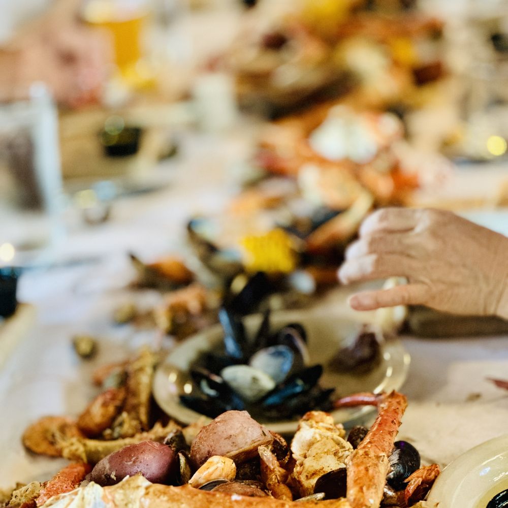 The Crab Pot Bellevue - a woman eating a crab pot - Seafood Near Me - Bellevue, Washington The Crab Pot Bellevue - a woman eating a crab pot - Seafood Near Me - Bellevue, Washington