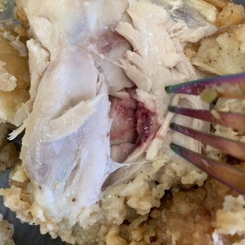 Lee's Famous Recipe Chicken - a fork digging into a piece of chicken - Chicken Wings Near Me - Fort Wayne, Indiana