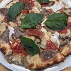 Tony D's pizzeria - Cauliflower pizza with basil sausage and mushrooms.