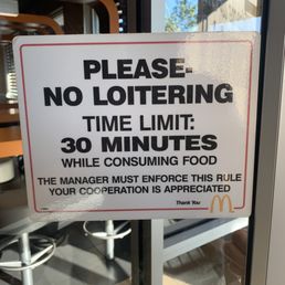 a no - lotering time limit sign a no - lotering time limit sign