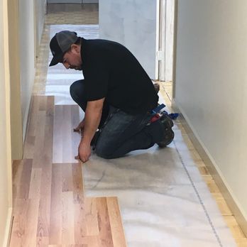 Total Construction - Workers installing laminate flooring. - General Contractors Near Me - Seattle, Washington