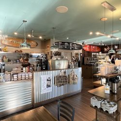 Fuel Coffee Bar - View of the shop from the corner of the store. There are some tables inside and chairs on the deck outside