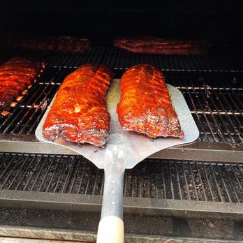 D&K Smokin' BBQ -  two ribs being cooked on a spatula - Barbeque Near Me