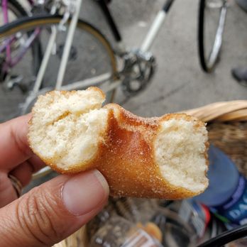 Sweet Bites - a hand holding a half eaten doughnut - Bakeries Near Me - Vineyard Haven, Massachusetts