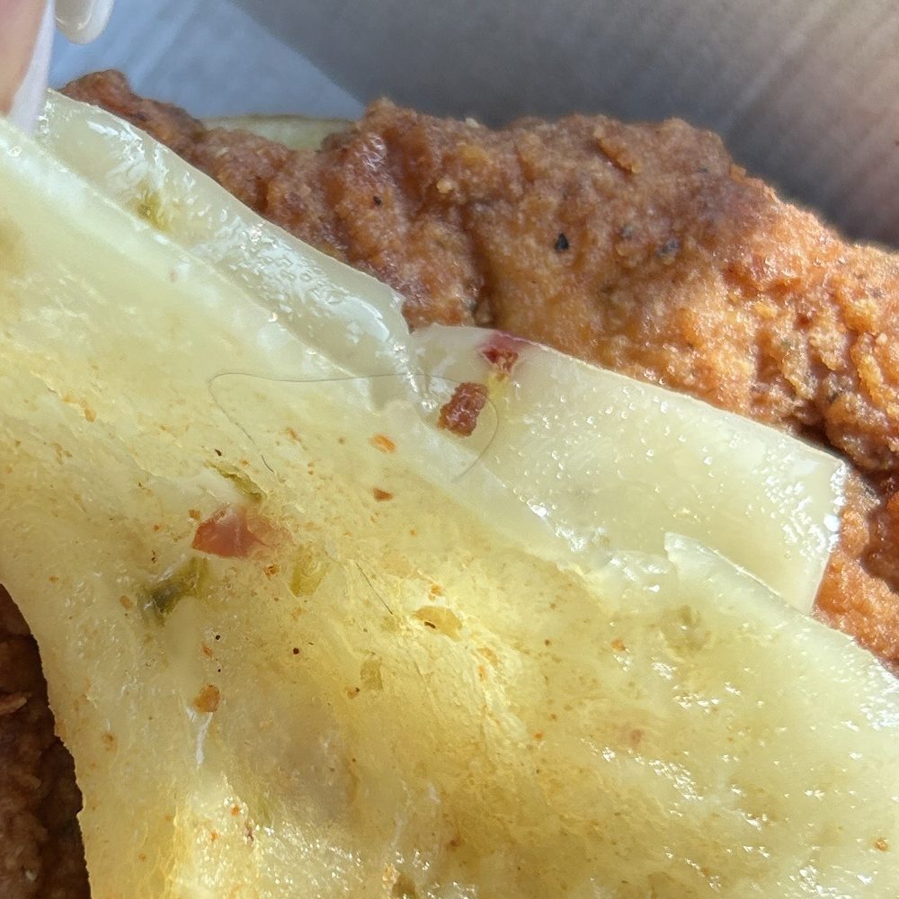 Chick-fil-A - Spicy Chicken Sandwich with hair stuck in the cheese - Fast Food Near Me - Austin, Texas Chick-fil-A - Spicy Chicken Sandwich with hair stuck in the cheese - Fast Food Near Me - Austin, Texas