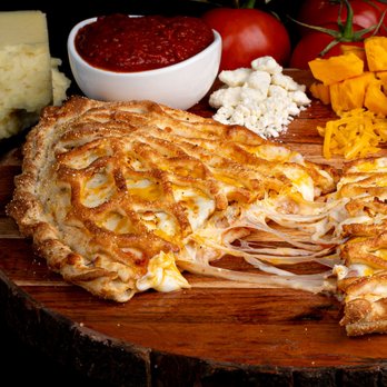 Calzone Life - a wooden cutting board with cheese, meat, and vegetables - Pizza Near Me - San Jose, California Calzone Life - a wooden cutting board with cheese, meat, and vegetables - Pizza Near Me - San Jose, California